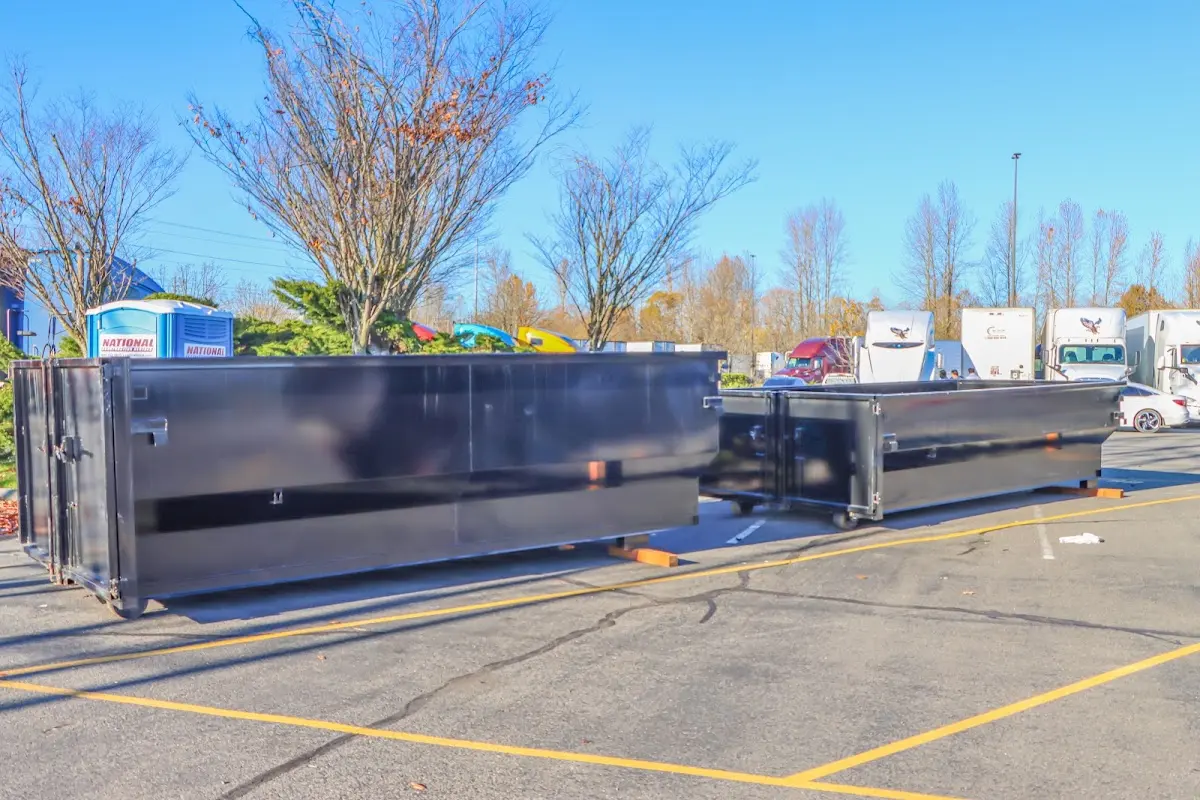 Professional dumpster rental service with roll-off container on residential driveway in Beaufort